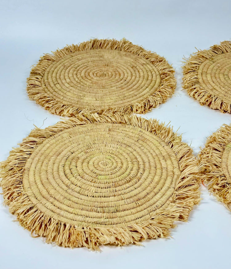 Handmade round raffia placemats with fringed edges - Natural table setting..