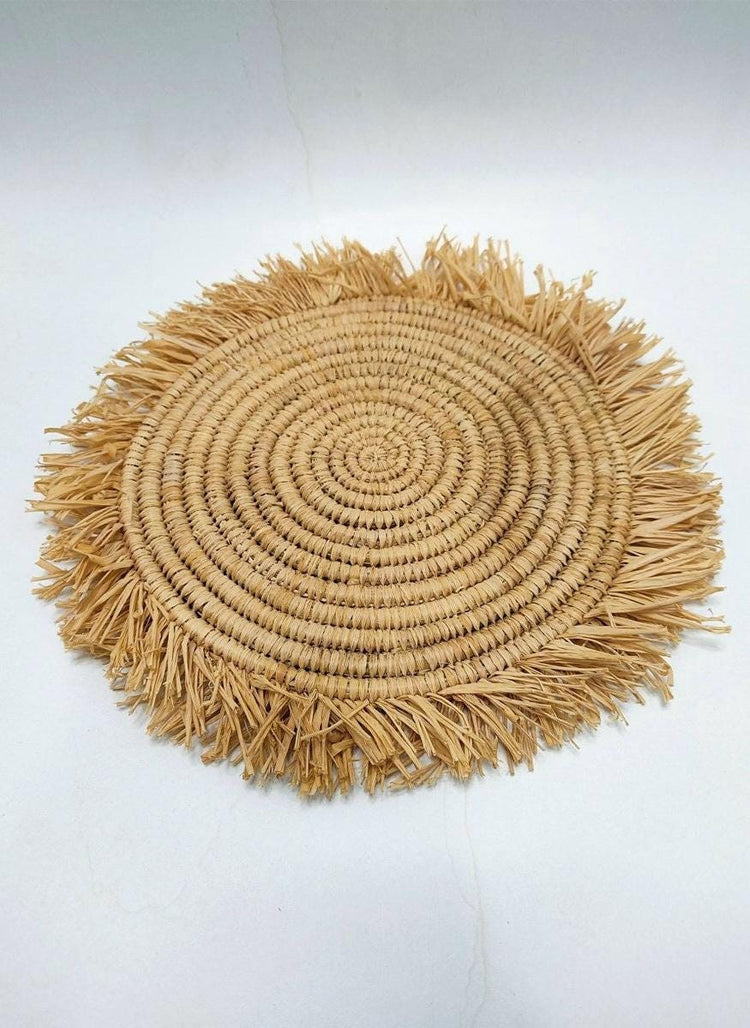 Handmade round raffia placemats with fringed edges - Natural table setting..