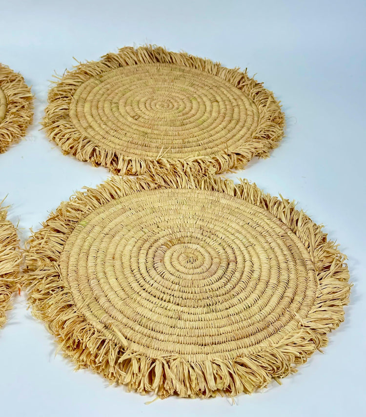 Handmade round raffia placemats with fringed edges - Natural table setting..