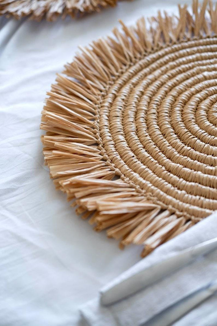 Handmade round raffia placemats with fringed edges - Natural table setting..
