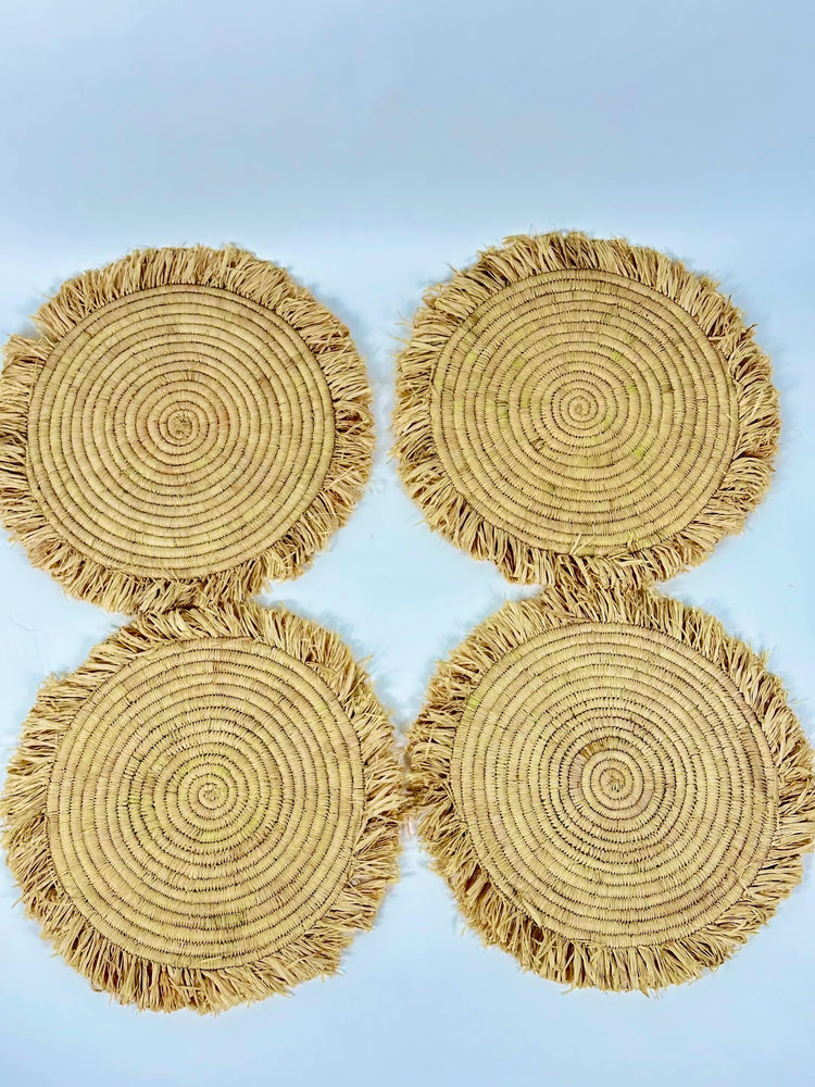 Handmade round raffia placemats with fringed edges - Natural table setting..