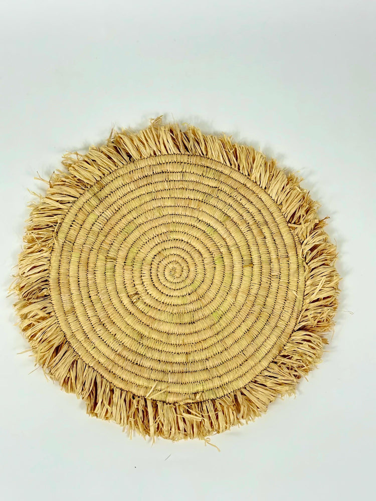 Handmade round raffia placemats with fringed edges - Natural table setting..