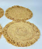 Handmade round raffia placemats with fringed edges - Natural table setting..